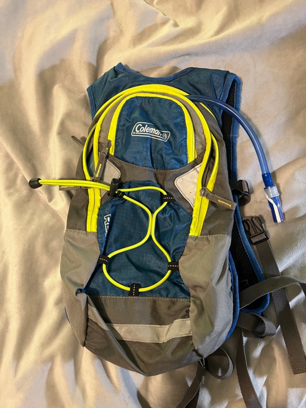 Coleman teal and neon yellow hydration pack